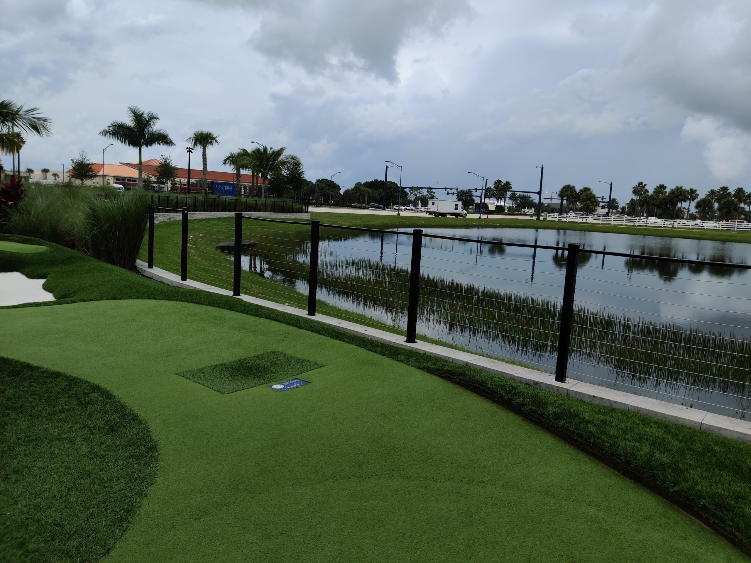 Golf Course fencing separates water feature from fairway FL